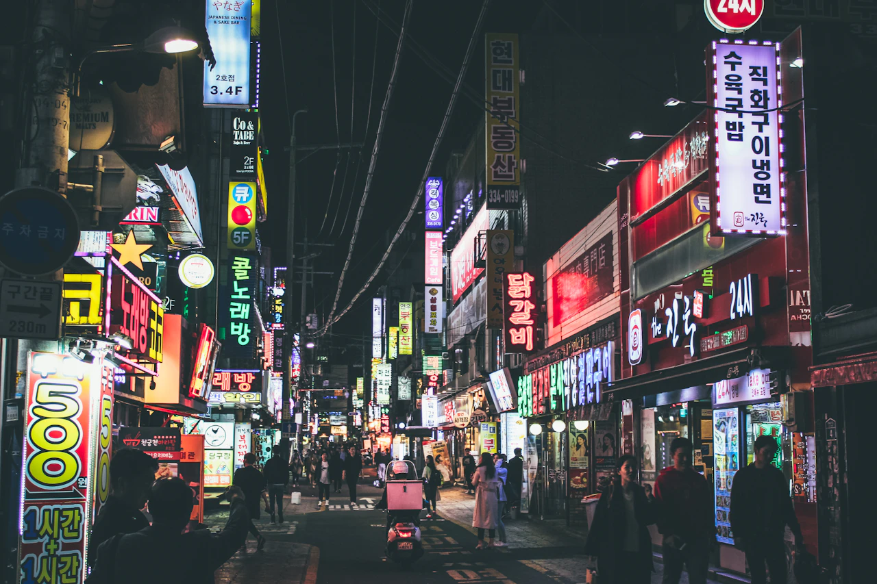 strada notturna con insegne luminose in una città coreana